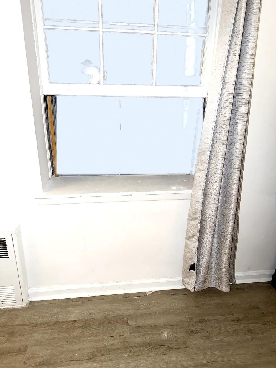 Bedroom window on September 2: wall below it sealed, primed and clean, no air conditioner