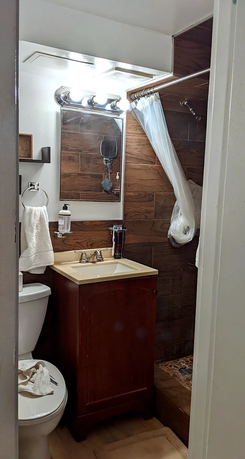 Downstairs bath in 2022: wood-look tile, vanity, shower curtain