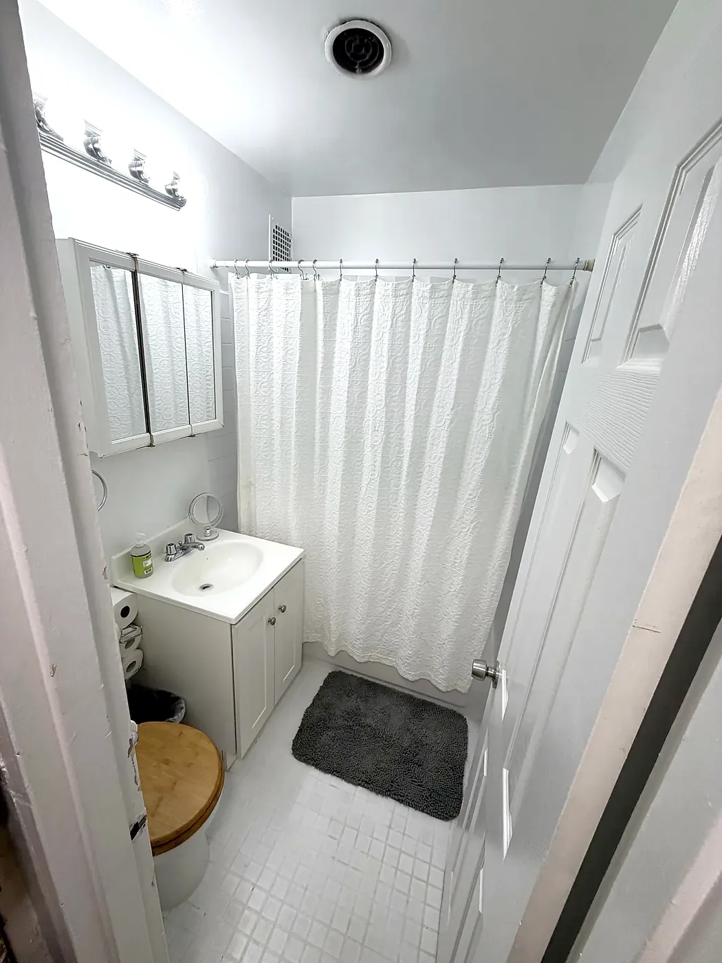 Upstairs bath in 2026: white walls, white shower curtain