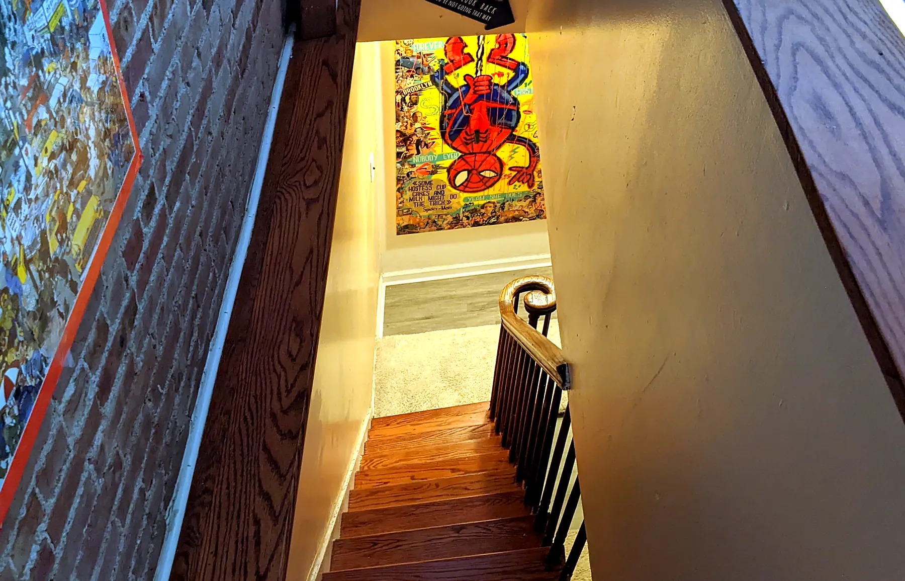 Stairs in 2022: poster at the bottom, tan walls