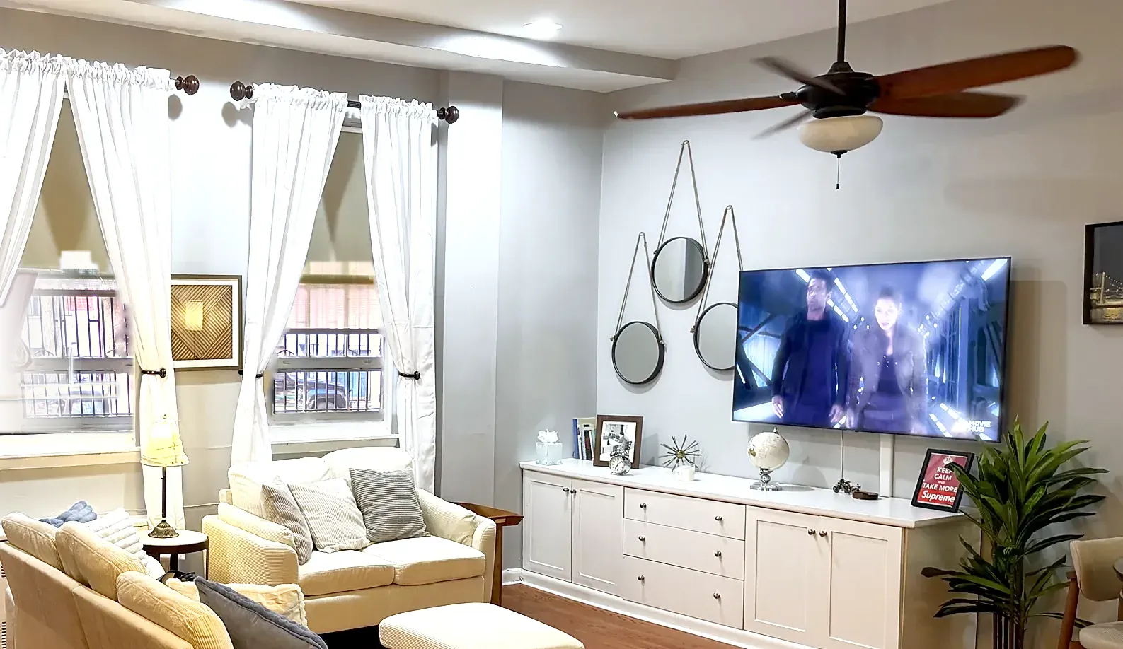 TV wall in 2026: grey walls, cream sofas, same white built-in cabinet