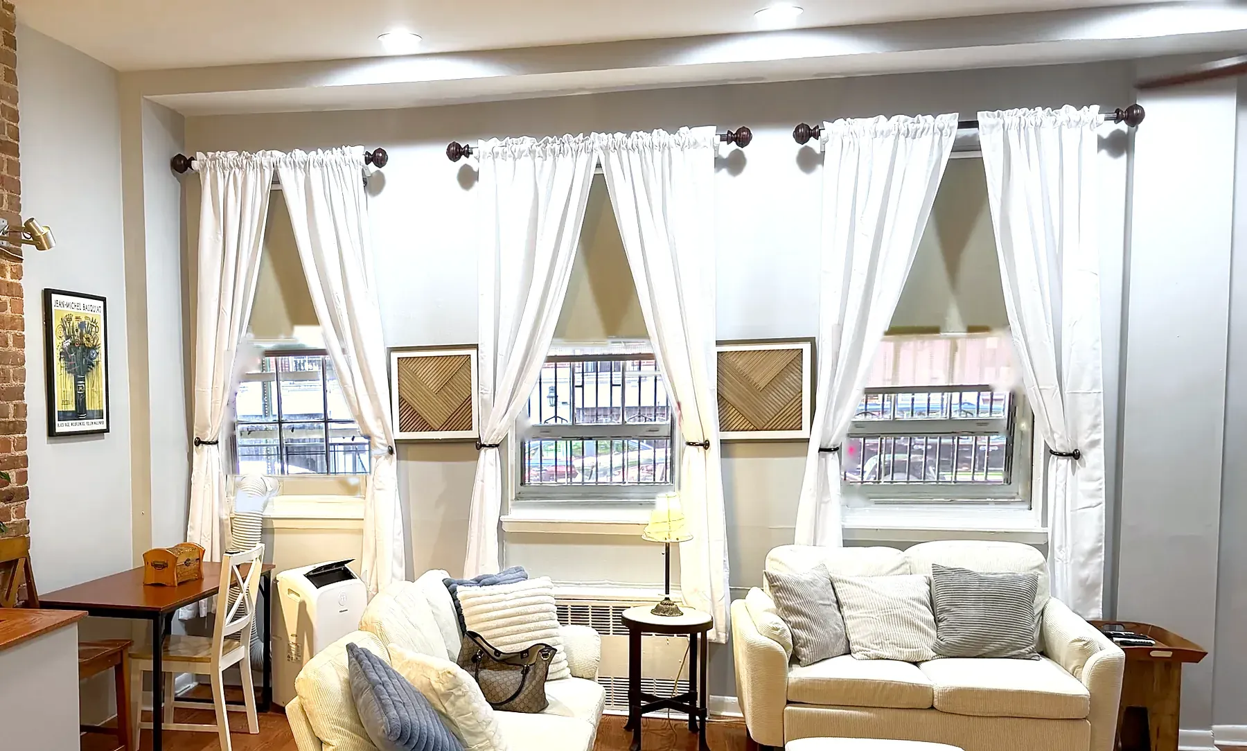 Living room windows in 2026: white curtains, grey walls, cream sofas